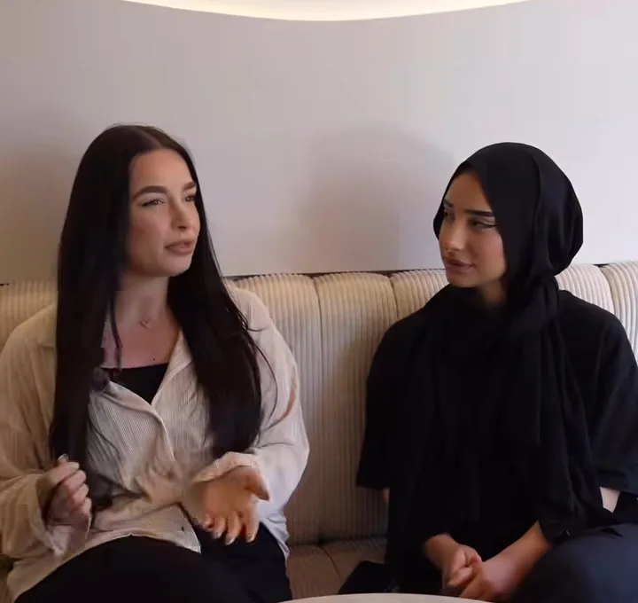 Twee vriendinnen aan een ronde tafel op de geribde bank bij COMO